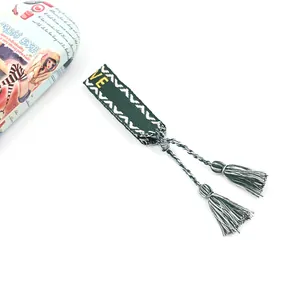 Ethnic bohemian woven tassel bracelet in dark green with yellow embroidered letters