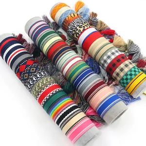 Close-up of colorful ethnic VIBES bracelets with intricate embroidery and tassels