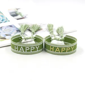 Πράσινα υφαστά βραχιόλια Happy με χρυσά γράμματα και χειροποίητες φούντες με κρόσσια