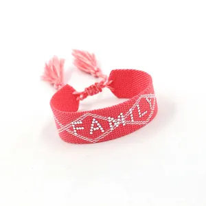 Macro shot of pink braided strap bracelet with FAMILY lettering and tassel closure