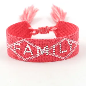 Pink woven friendship bracelet featuring FAMILY text and adjustable tassels