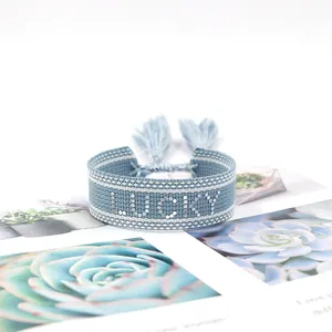 Ethnic μπλε υφαντό βραχιόλι με ασημί παγιέτες LUCKY και κλείσιμο με φούντες