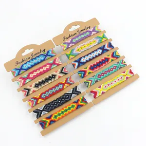 Close-up of 12 handmade woven friendship bracelets with vibrant geometric patterns
