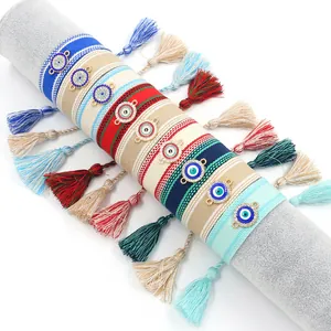 Bohemian woven evil eye bracelets with gold metal accents and colorful tassels