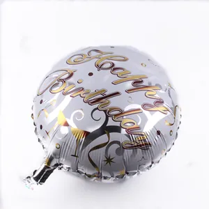 Detail showing a silver round birthday balloon with golden Happy Birthday lettering