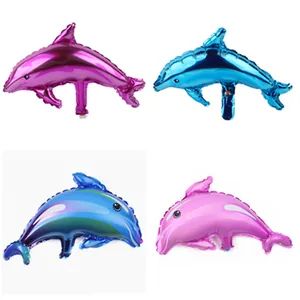 Detailed view of dolphin-shaped foil balloons in purple, blue, teal, and pink colors