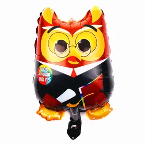 Macro shot of a cartoon owl graduation foil balloon with Look Whoooo Did It text details