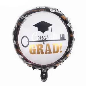 Detail of graduation foil balloon with Congrats GRAD text and academic cap design