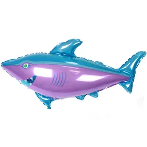 Detail view of blue and purple shark foil balloon with green eyes and white teeth