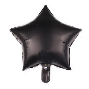 Matte black star-shaped aluminum foil balloon detail with a clear inflation valve port
