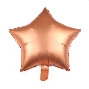 Detail view of heart-shaped rose gold foil balloon with metallic texture on white background