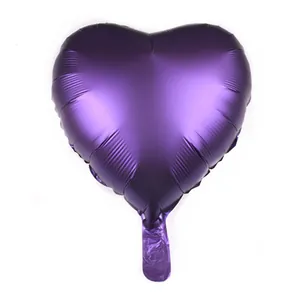 Close-up of heart-shaped purple foil balloon with metallic finish and inflation valve