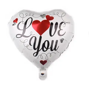 Close-up of heart-shaped foil balloon with white finish and LOVE You printed design