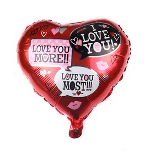 Close-up of red heart foil balloon with Love You More text and pink kiss print details