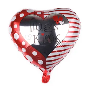 Detail of heart foil balloon featuring hugs Kisses print with red dots and stripes design