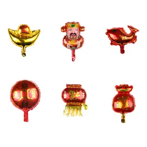 Detailed close-up of mini Lunar New Year foil balloons featuring gold ingots and koi fish
