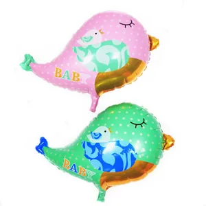 Close-up of pink and green bird balloons with baby text for birthday party decor