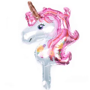 Close-up of a pink unicorn foil balloon with floral details and metallic texture