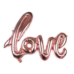 Detailed view of rose gold Love script foil balloon with shiny metallic texture and finish