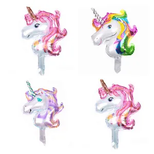 Detail view of four colorful unicorn foil balloons for birthday party decorations