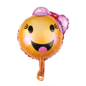 Macro detail of smiley face foil balloon with pink bow for party decoration