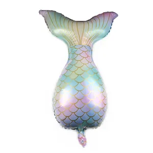 Close-up of iridescent mermaid tail foil balloon featuring golden fish scale texture