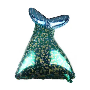 Detailed view of mermaid tail foil balloon with green fish scale patterns and blue fins