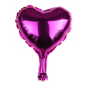 Detail of a purple heart-shaped foil balloon with a metallic finish for party decorations