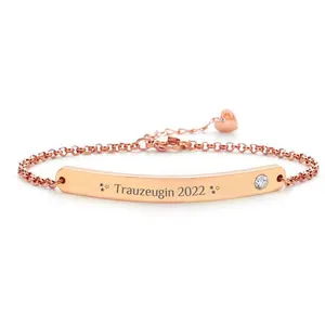 Bracelet en acier inoxydable or rose avec plaque gravée, cristal blanc et cœur