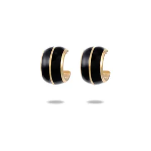 Elegant gold and black C-shaped enamel hoop earrings with a minimalist luxury design
