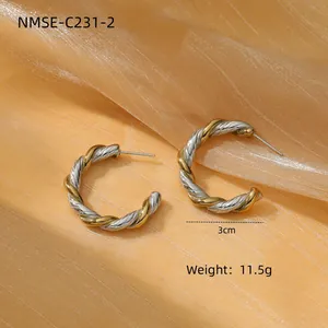 Detailed view of 3cm twisted C-shape hoop earrings with gold and silver woven texture