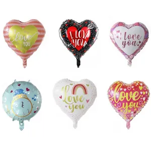 Detail view of heart and ring foil balloons with stripes, dots, and I Love You prints