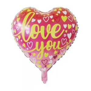 Detail of heart-shaped foil balloon with Love you text and colorful small heart patterns