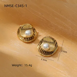 Macro shot of 2.3cm golden ripple pearl earrings with 15.4g weight on silk background