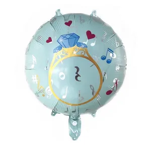 Detail of round foil balloon with diamond ring and musical note pattern design