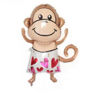 Detail of monkey shaped foil balloon with heart patterns for birthday party decoration
