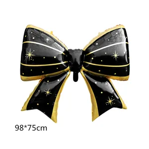 Large black and gold bow-shaped foil balloon with star patterns for party decor, 98x75cm