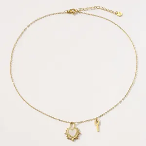 Collar de acero dorado con candado de corazón de nácar, sol radiante y mini llave
