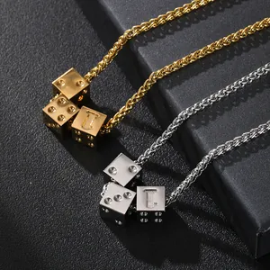 Macro shot of silver and gold dice pendants with twisted rope chain in stainless steel