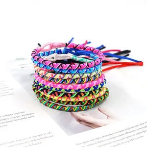 Close-up of colorful woven friendship bracelets with adjustable bohemian tassel design
