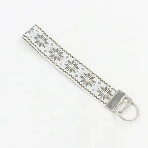 Close-up of woven geometric snowflake pattern on fabric wristlet keychain strap