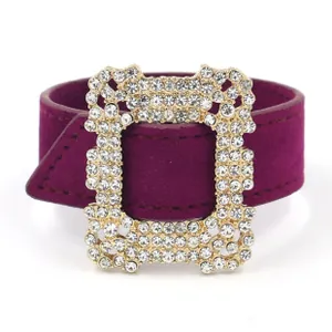 Close-up of luxury purple suede leather bracelet featuring a rhinestone encrusted gold buckle