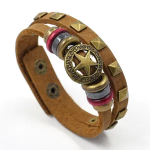 Detail of punk leather bracelet with bronze star emblem and metallic studs