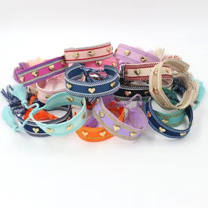 Handwoven bohemian bracelets set with golden heart studs and colorful fringe tassels