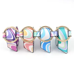 Close-up of golden metal ring buckle on colorful wave pattern PU leather bracelets