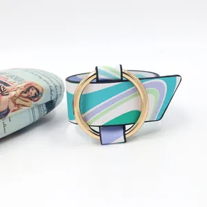 Detail of wide PU leather cuff bracelet featuring colorful wave pattern and gold metal buckle
