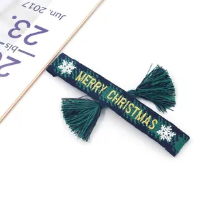 Woven Christmas bracelet with Merry Christmas embroidery and festive tassels