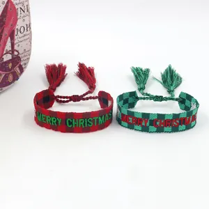 Close-up of Merry Christmas embroidered woven bracelets with tassels and plaid patterns