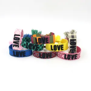 Detailed set of 8 woven bracelets featuring 3D embroidered LOVE text and tassels