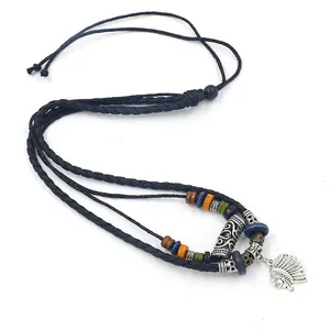 Detail of beaded tribal necklace featuring an Indian chief pendant and woven cord